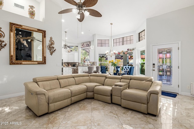 6941 W Voltaire Ave, Peoria, AZ 85381 - living room with high vaulted ceiling, ceiling fan, light marble finish floors, and baseboards