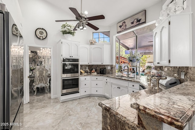 6941 W Voltaire Ave, Peoria, AZ 85381 - kitchen with a sink, stainless steel appliances, backsplash, a ceiling fan, and light stone counters