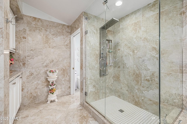 6941 W Voltaire Ave, Peoria, AZ 85381 - bathroom with a stall shower, vaulted ceiling, and vanity