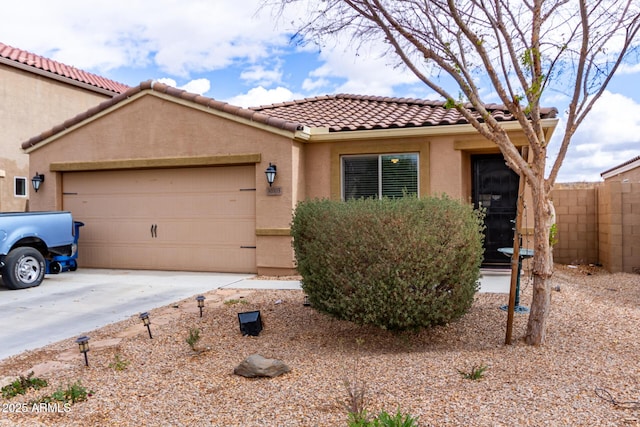 mediterranean / spanish-style house featuring stucco siding, concrete driveway, fence, a garage, and a tiled roof