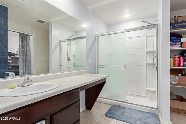 full bathroom featuring visible vents, a shower stall, vanity, and tile patterned floors