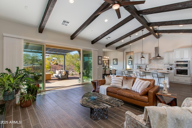 living room featuring beam ceiling, ceiling fan, and high vaulted ceiling