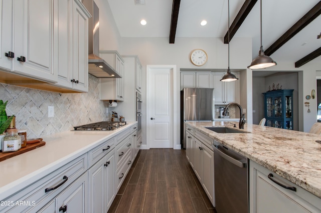 kitchen featuring pendant lighting, sink, wall chimney exhaust hood, beam ceiling, and stainless steel appliances