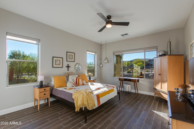 bedroom with dark hardwood / wood-style floors and ceiling fan