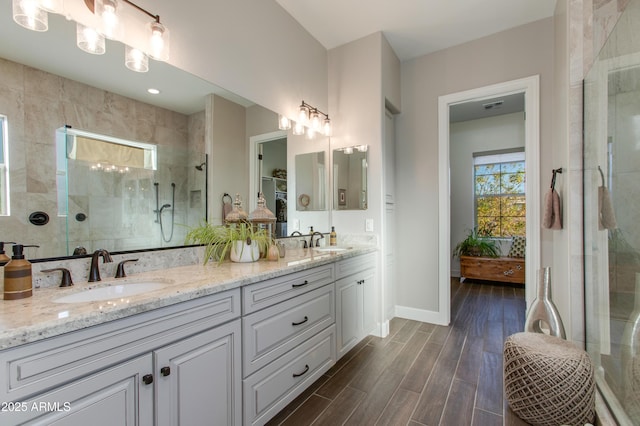 bathroom with vanity and tiled shower