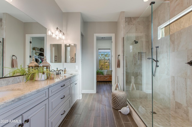 bathroom featuring vanity and a shower with door