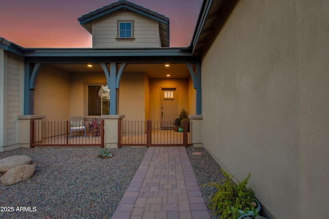 view of exterior entry at dusk