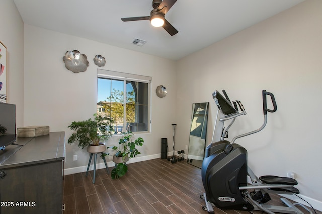 workout room with ceiling fan and dark wood-type flooring