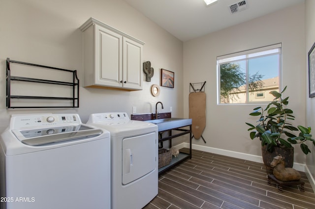 washroom with cabinets, dark hardwood / wood-style flooring, separate washer and dryer, and sink