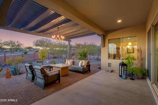 patio terrace at dusk with an outdoor hangout area and a pergola