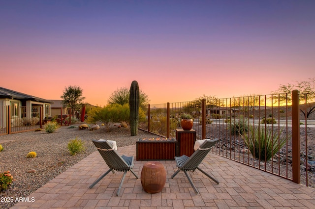 view of patio terrace at dusk