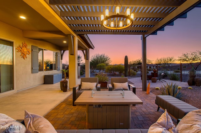 patio terrace at dusk featuring a pergola and outdoor lounge area