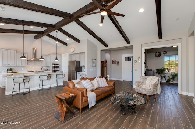 living room featuring beamed ceiling, ceiling fan, and high vaulted ceiling