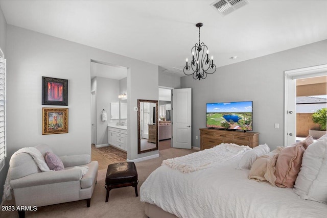 carpeted bedroom featuring connected bathroom and a notable chandelier