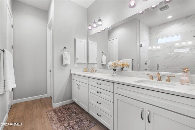 bathroom with vanity, an enclosed shower, and hardwood / wood-style floors