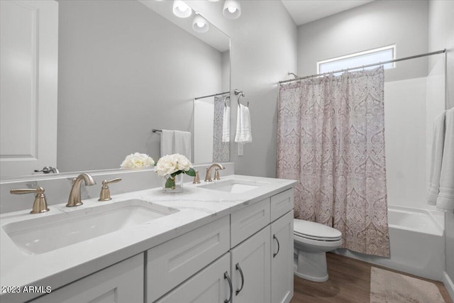 full bathroom with vanity, toilet, shower / tub combo, and hardwood / wood-style floors