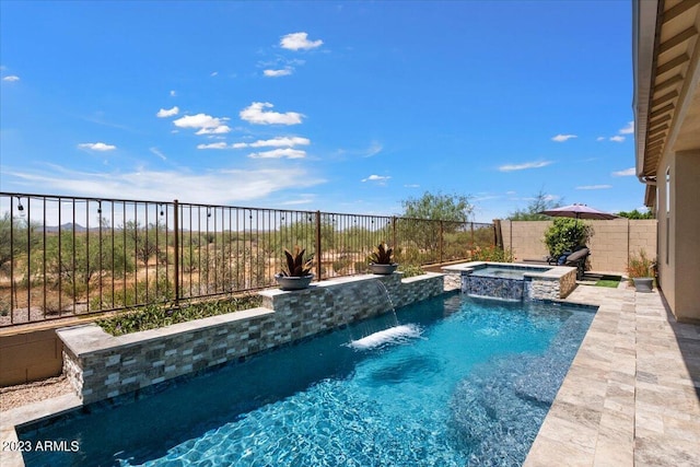 view of swimming pool featuring pool water feature and an in ground hot tub