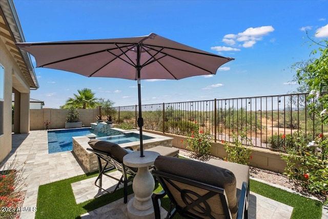 view of patio / terrace with a pool with hot tub