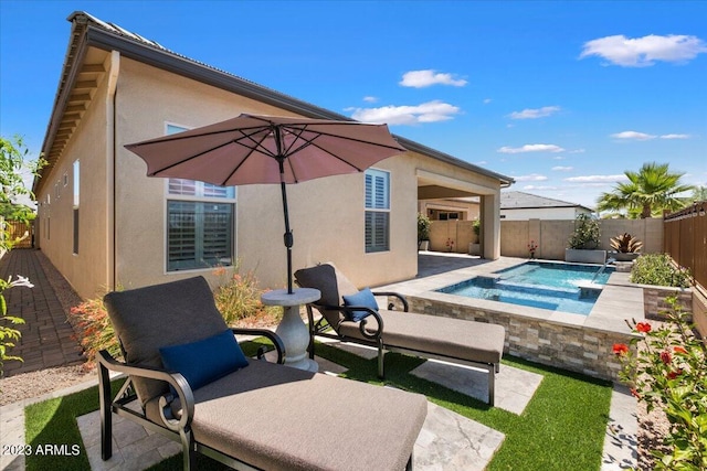 view of swimming pool featuring a patio, pool water feature, and an in ground hot tub