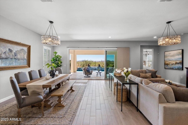 dining room with hardwood / wood-style floors and a chandelier