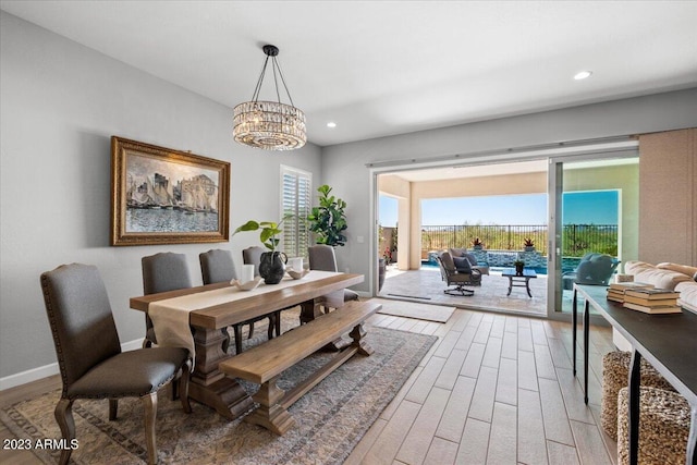 dining area featuring an inviting chandelier and hardwood / wood-style floors