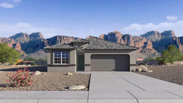 ranch-style house featuring an attached garage, a mountain view, concrete driveway, and stucco siding