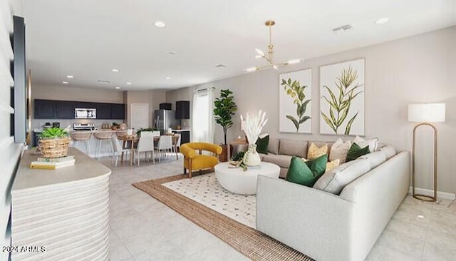 living room featuring recessed lighting, visible vents, a notable chandelier, and baseboards