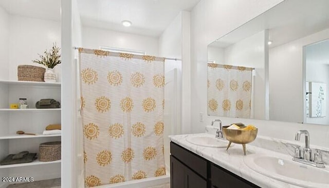 full bath with double vanity, a shower with shower curtain, and a sink