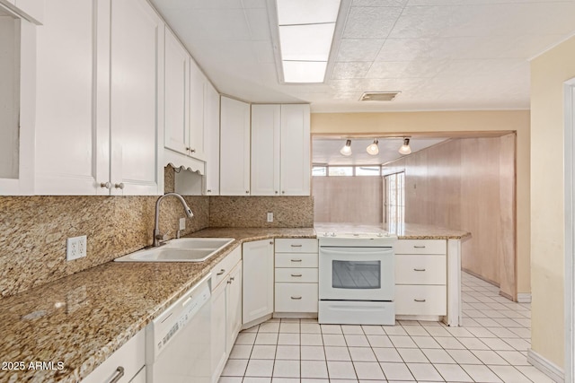 kitchen with sink, white cabinetry, white appliances, light stone countertops, and decorative backsplash