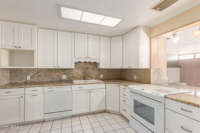 kitchen featuring sink, white appliances, white cabinetry, backsplash, and light stone counters