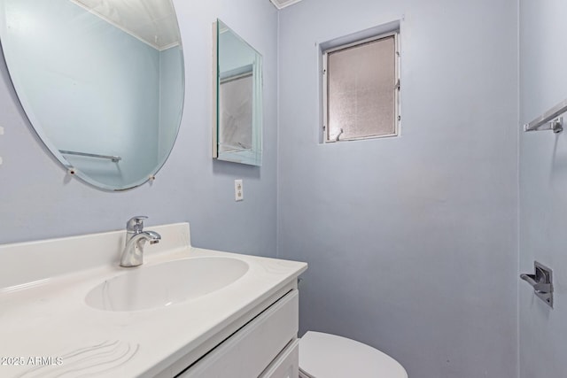 bathroom featuring vanity and toilet