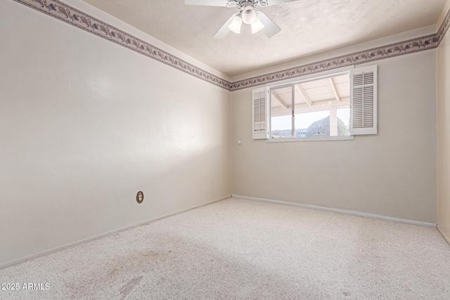 empty room with ceiling fan, carpet, and a textured ceiling