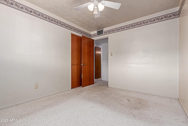 unfurnished room with a textured ceiling and ceiling fan