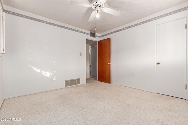 unfurnished bedroom with a textured ceiling and ceiling fan