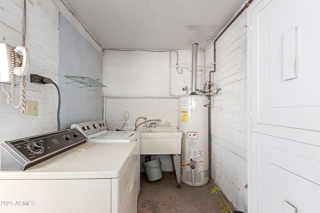 clothes washing area with washer and dryer and gas water heater