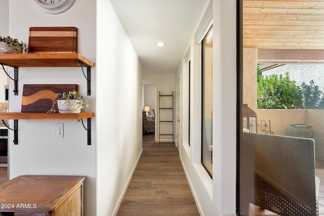 hall with dark hardwood / wood-style floors and wooden ceiling