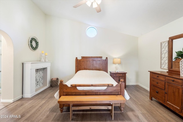 bedroom with ceiling fan, light hardwood / wood-style floors, and lofted ceiling