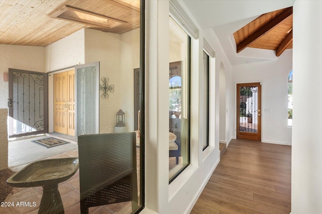 hall featuring wooden ceiling, lofted ceiling, and wood-type flooring