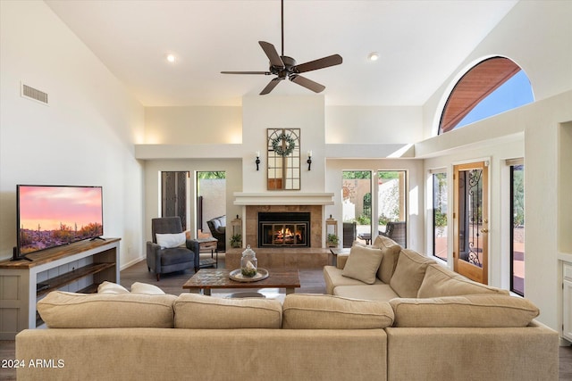 living room with a high ceiling, a healthy amount of sunlight, and hardwood / wood-style floors