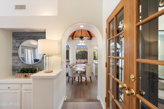 interior space featuring hardwood / wood-style flooring, ceiling fan, and beam ceiling