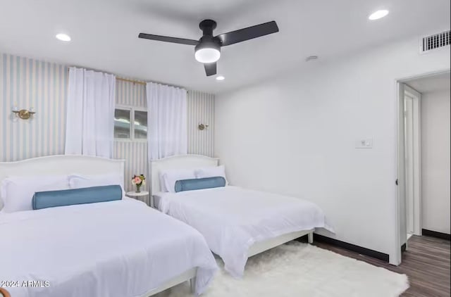 bedroom with ceiling fan and dark hardwood / wood-style flooring