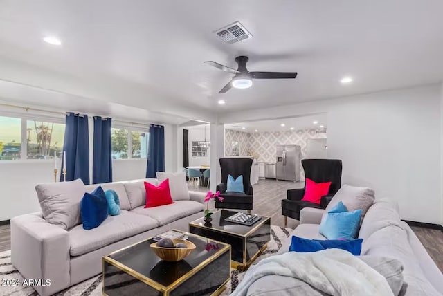 living room with ceiling fan and wood-type flooring