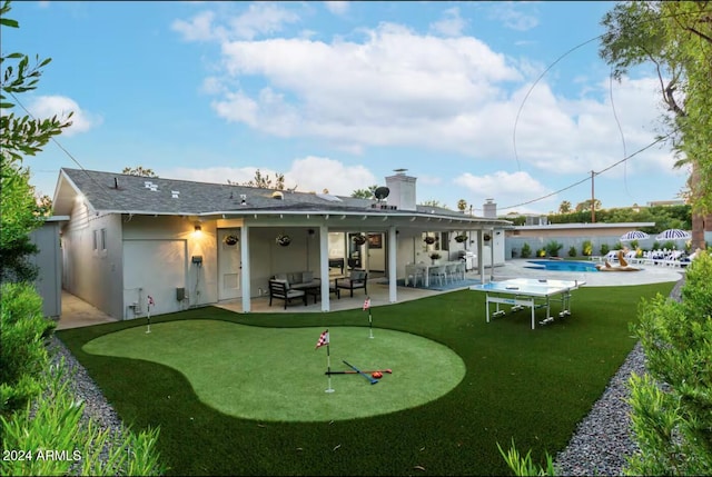 back of house featuring a patio and outdoor lounge area