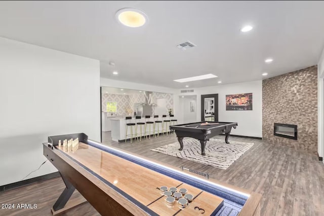 rec room with bar area, hardwood / wood-style flooring, and billiards