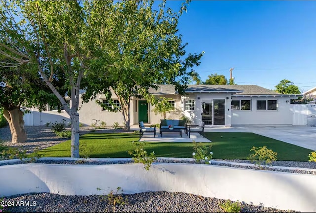 view of front of property with a patio area, a front lawn, and an outdoor hangout area