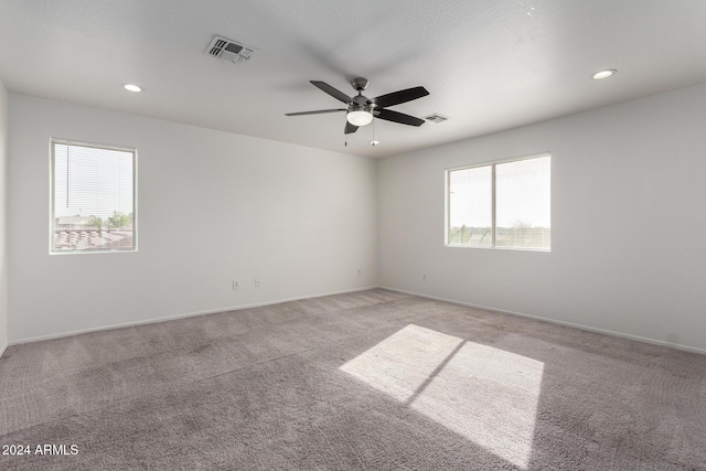 unfurnished room featuring light carpet and ceiling fan