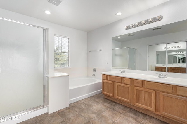 bathroom featuring separate shower and tub, tile patterned floors, and vanity