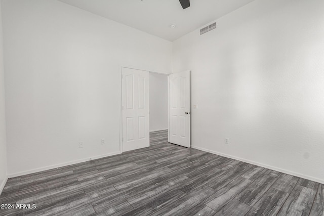 spare room featuring ceiling fan and dark hardwood / wood-style flooring