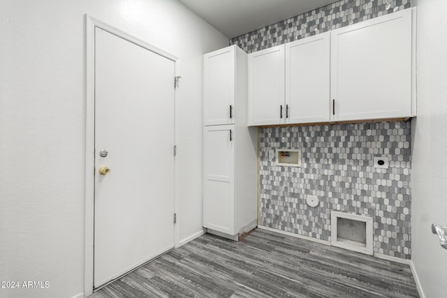 clothes washing area with hardwood / wood-style flooring and cabinets