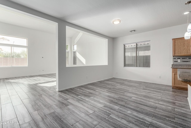 unfurnished living room featuring light wood-type flooring